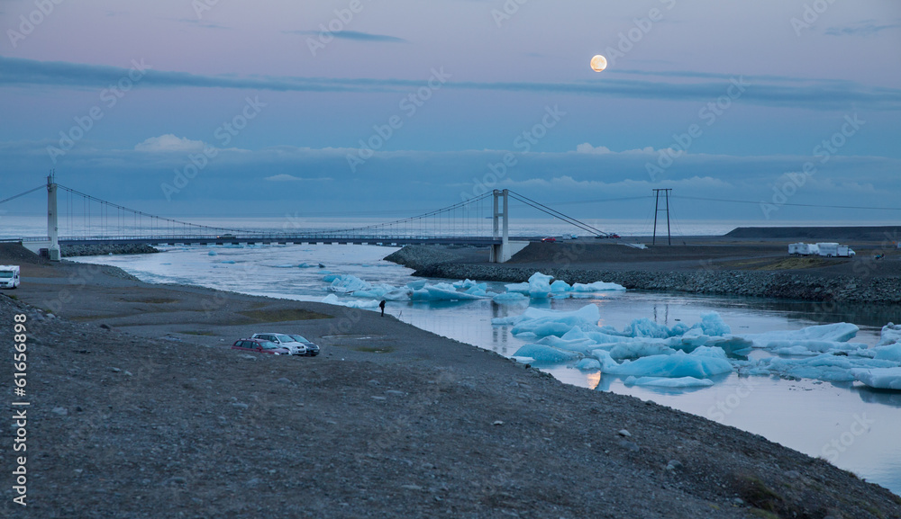 blue icebergs floating and full moon