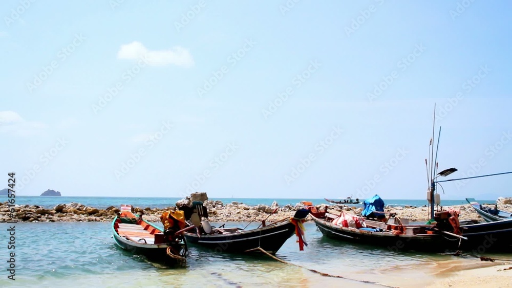 fishing boats lie down on a tropical beach fishing boats lie down on a tropical beach