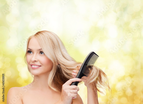 smiling woman with hair brush