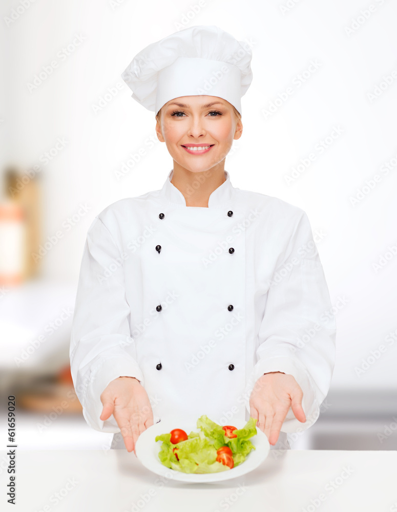smiling female chef with salad on plate smiling female chef with salad on plate