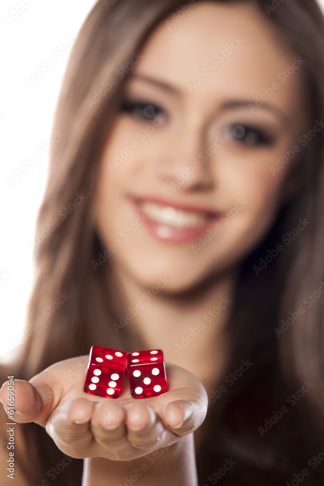 smiling girl holding a pair of dice for gambling smiling girl holding a pair of dice for gambling