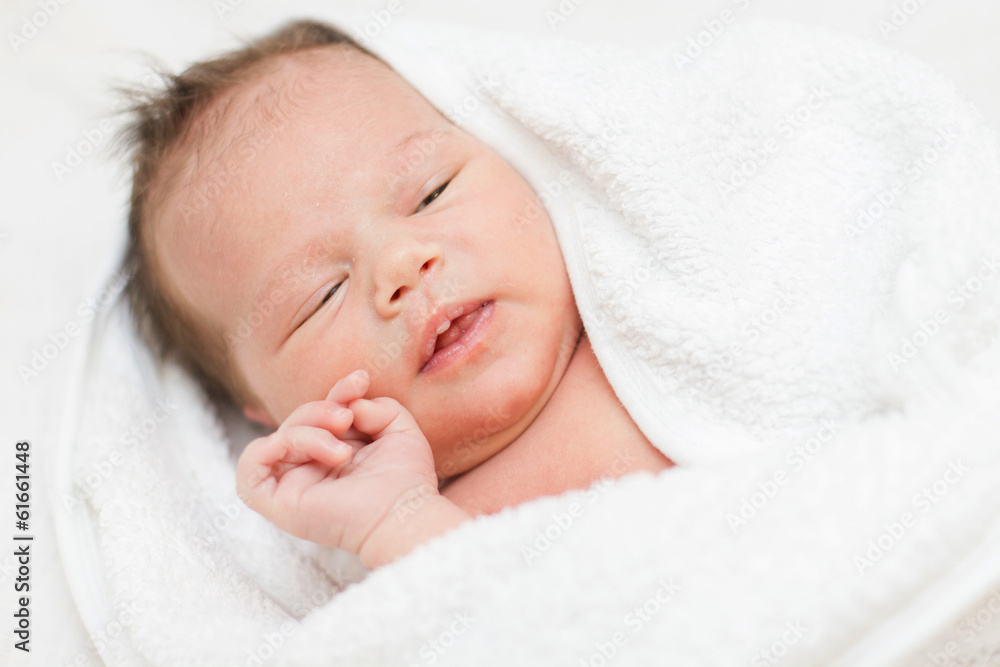 newborn baby with towel