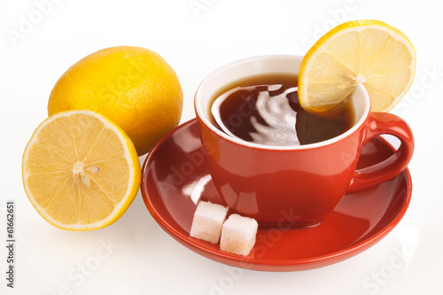 Cup of tea with lemon and sugar cubes