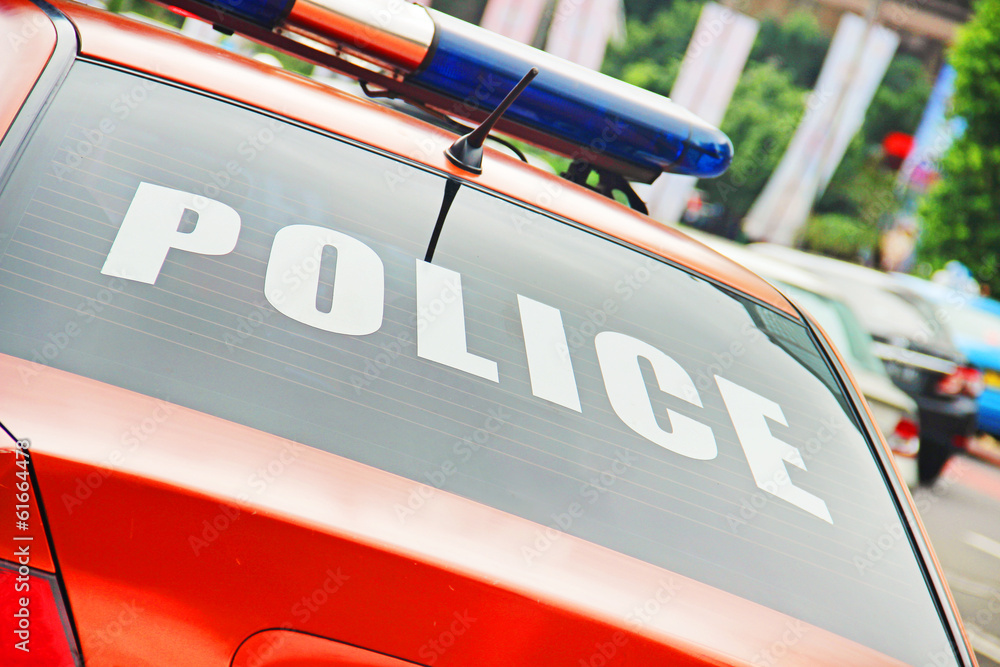 Obraz premium Closeup of the orange police car with a sign POLICE