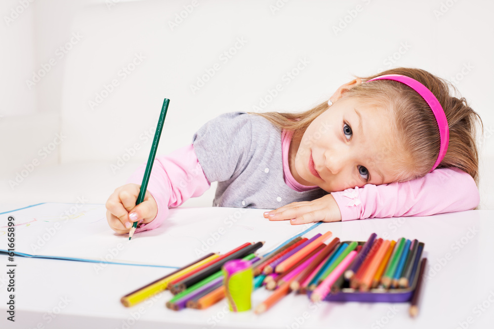 Cute little girl drawing colored pencils at home. Cute little girl drawing colored pencils at home.
