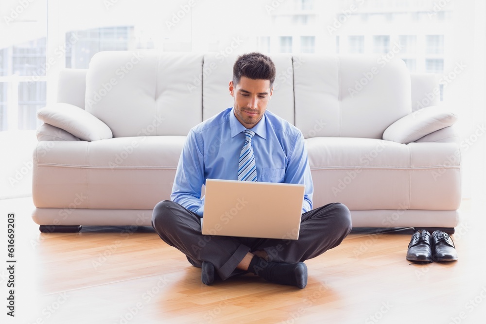Businessman sitting on floor using laptop Businessman sitting on floor using laptop