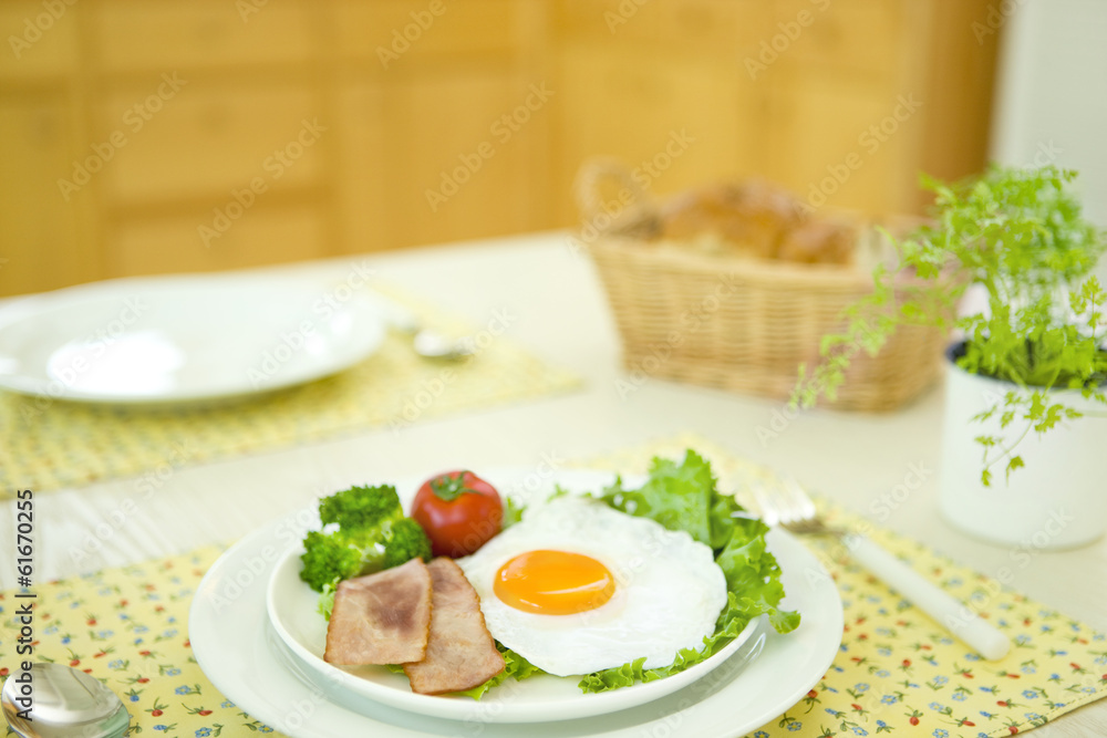 Breakfast of fried egg and chervil on a table