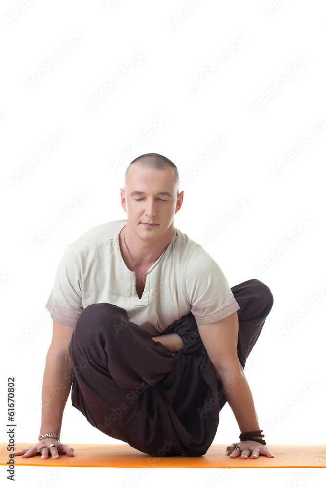 Studio shot of meditator man in difficult asana Studio shot of meditator man in difficult asana