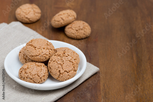 biscotti cookies in a bowl on a wooden table and space for text