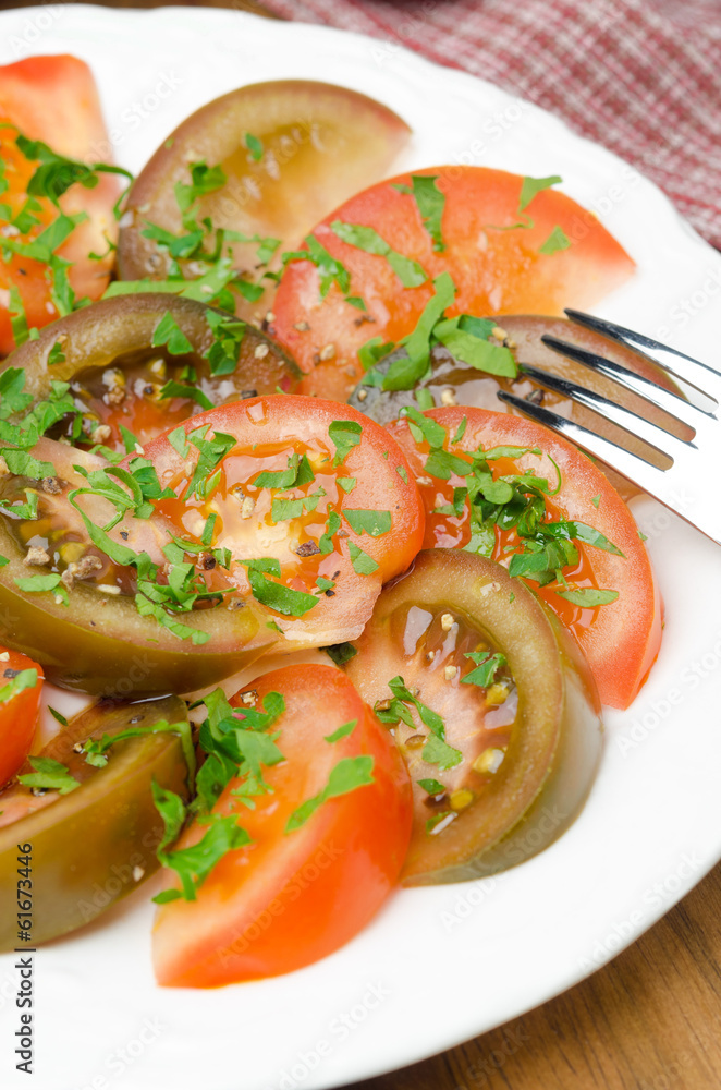 salad of two varieties of tomatoes with fresh parsley vertical salad of two varieties of tomatoes with fresh parsley vertical