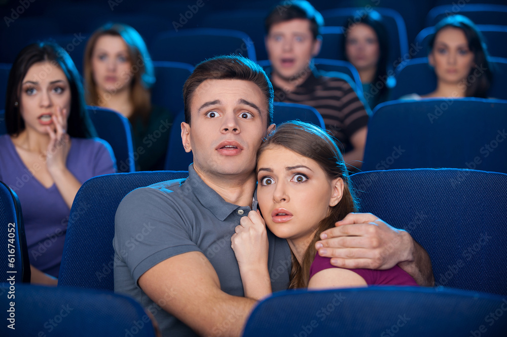 Naklejka premium Watching horror movie.