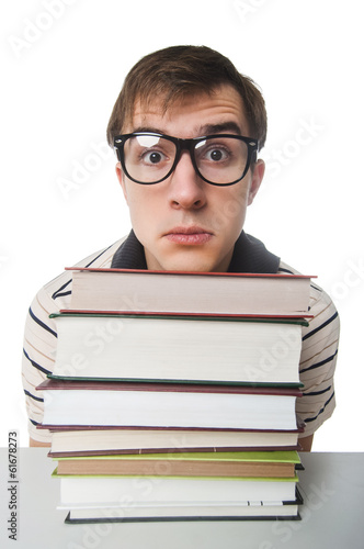 Male student at the table with pile of books