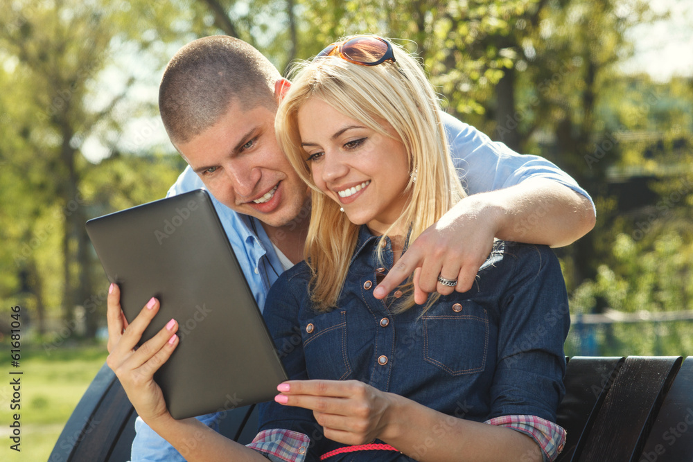 Modern young couple using a digital tablet Modern young couple using a digital tablet