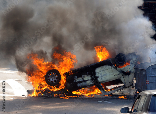 Burned car at street riots photo