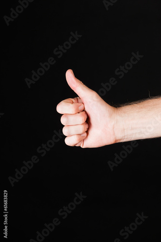 Male hand showing thumbs up