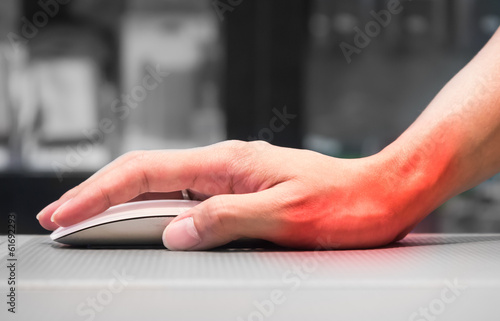 Hand holding computer mouse having wrist pain photo