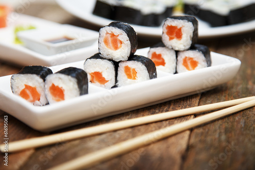 A set of salmon sushi with chopsticks