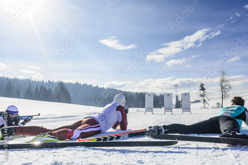 Drei Biathleten beim Schießen photo