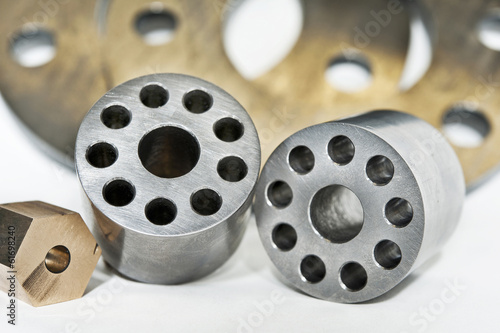 Metal flanges cylinders and brass nuts.