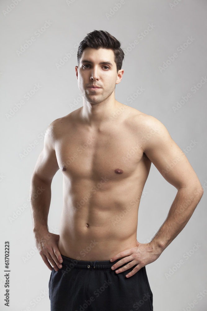half naked man lifting weights