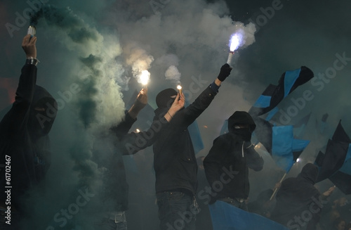 Soccer fans in smoke with fireworks photo
