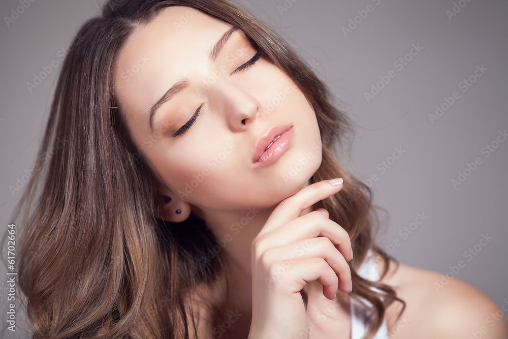 Portrait of beautiful woman over gray background Portrait of beautiful woman over gray background