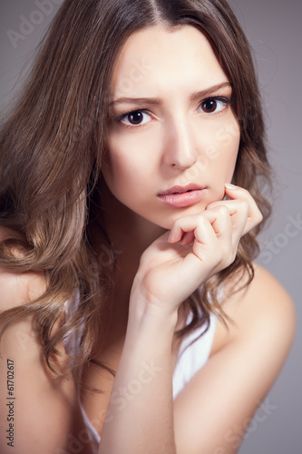 Portrait of beautiful woman over gray background