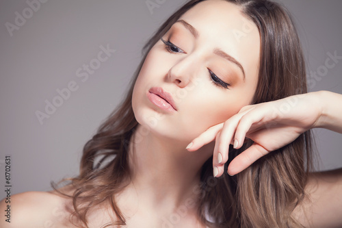 beautiful woman over gray background, head and shoulders