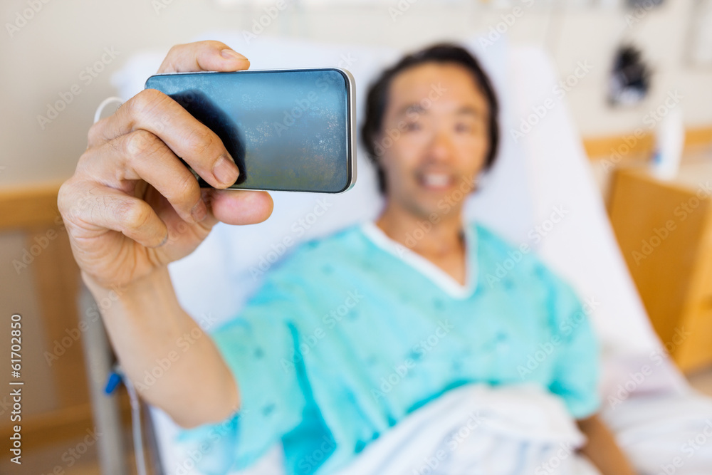 Patient Taking Self Portrait Through Mobile Phone In Hospital Patient Taking Self Portrait Through Mobile Phone In Hospital