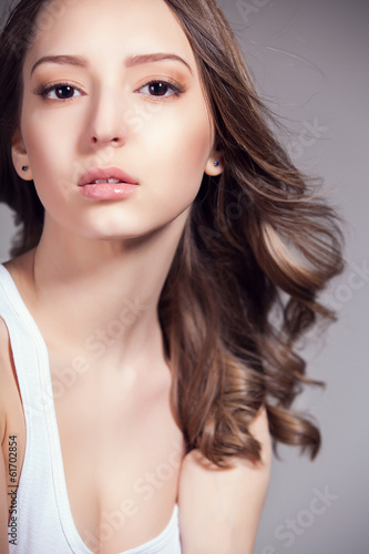 beautiful woman over gray background, head and shoulders