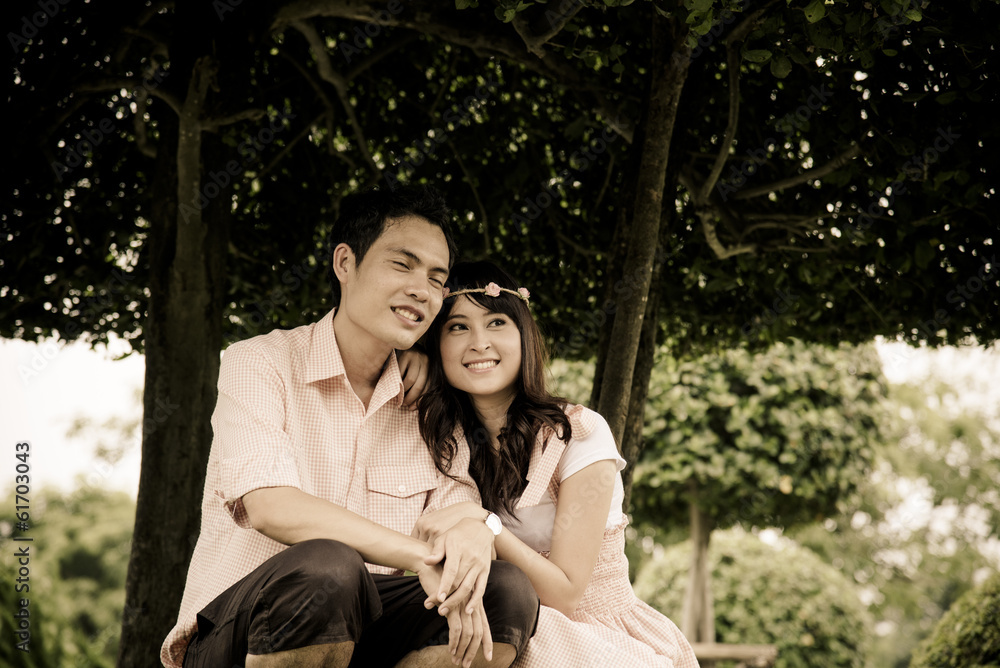 Lovely couple sit under the tree Lovely couple sit under the tree