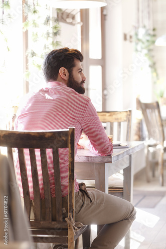 Young man sitting in coffee shop.