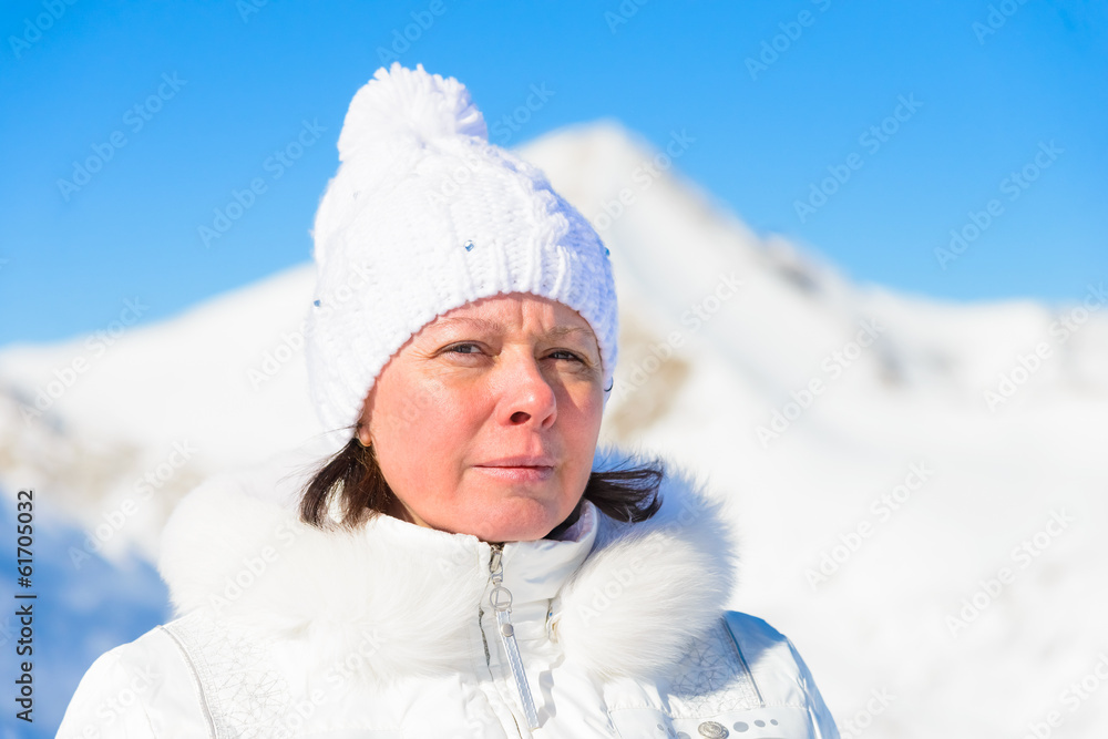 woman in ski suit on a background of mountains woman in ski suit on a background of mountains