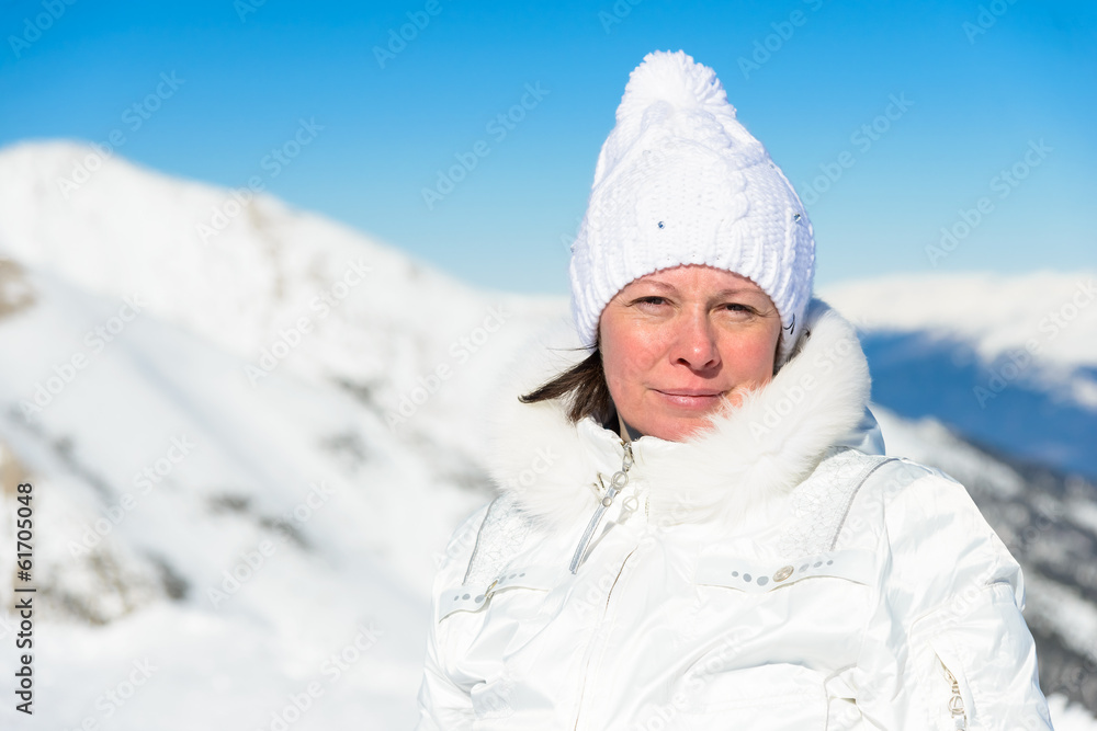 woman in ski suit on a background of mountains woman in ski suit on a background of mountains
