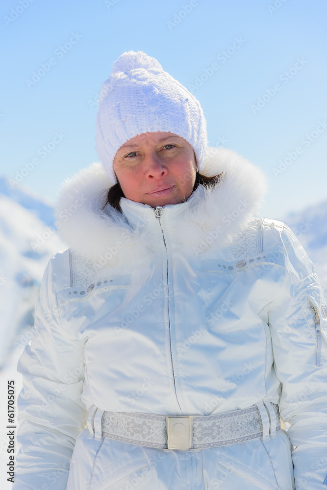 woman in ski suit on a background of mountains woman in ski suit on a background of mountains