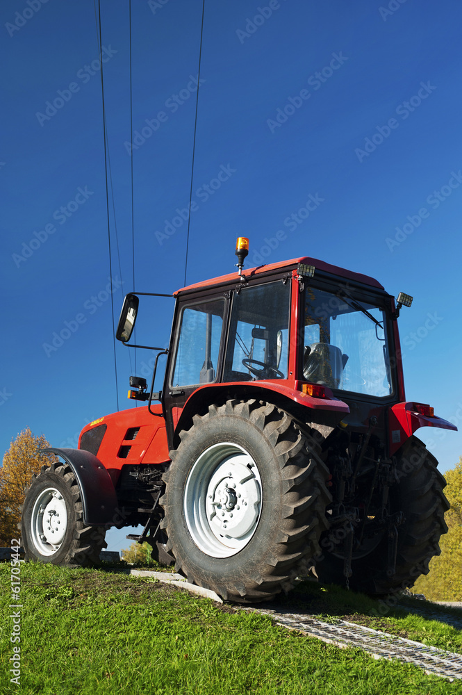 Modern red tractor outdoors Modern red tractor outdoors