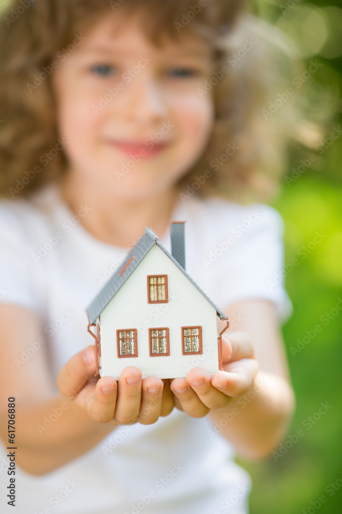 Child holding house Child holding house