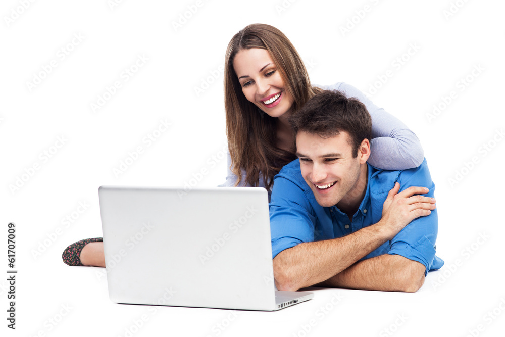 Couple lying and using laptop Couple lying and using laptop