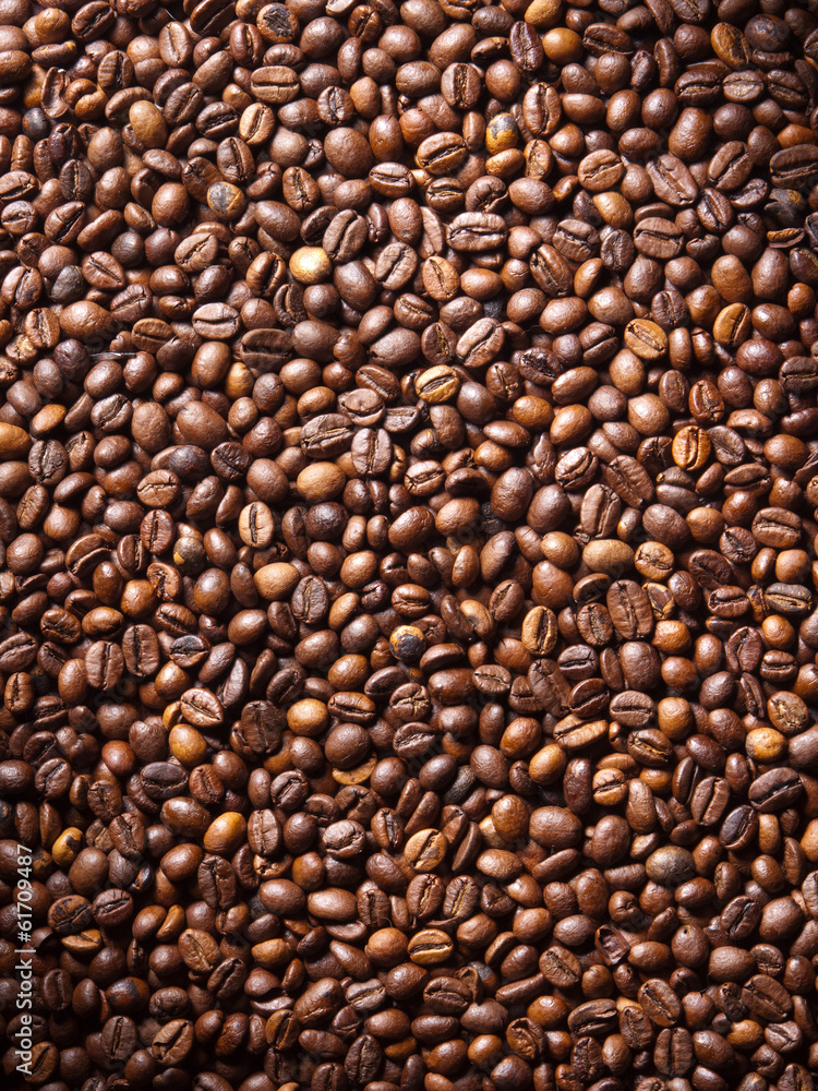 Numerous coffee beans which have been scattered all over the sur Numerous coffee beans which have been scattered all over the sur