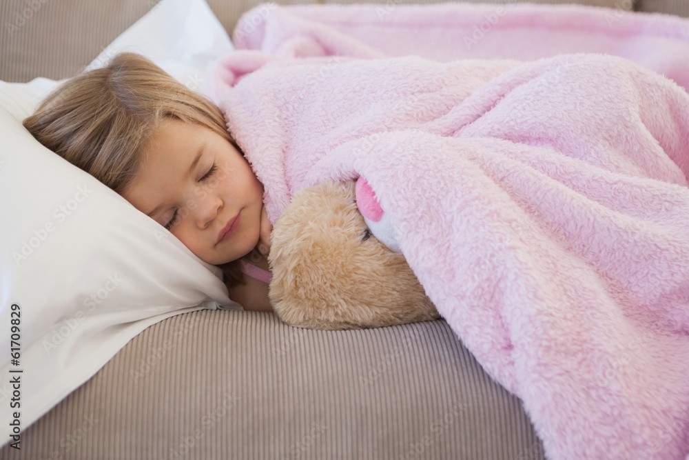Close-up of a girl sleeping on sofa with stuffed toy Close-up of a girl sleeping on sofa with stuffed toy