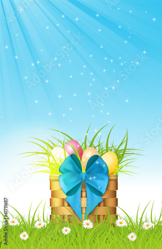 wooden basket with easter eggs on fresh grass