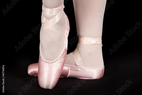 A ballet dancer standing on toes while dancing artistic conversi photo