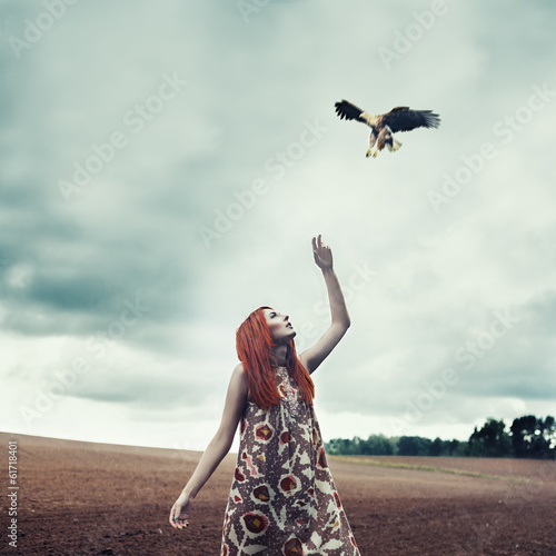 Art portrait of a girl in the rain with bird