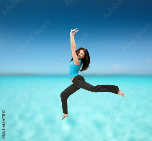 sporty woman jumping in sportswear