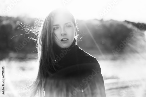 Beautiful sexy girl on the street against the sun