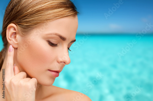 calm woman touching her ear photo