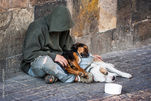 beggar with two Dogs near Charles Bridge, Prague photo