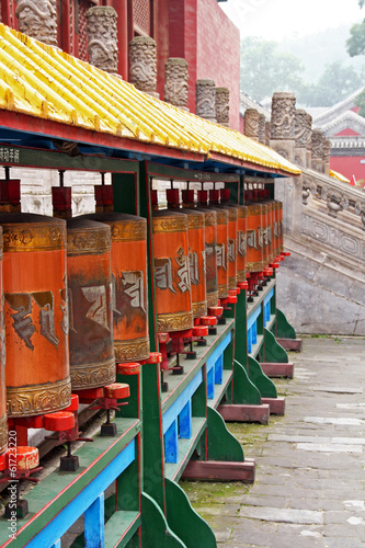 Row of Tibetan prayer-wheels in Chengde, China