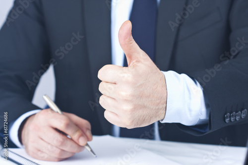 Businessman with hand in approval and okay photo