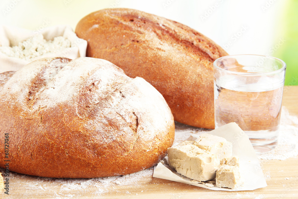 Composition with rye bread on table on bright background Composition with rye bread on table on bright background